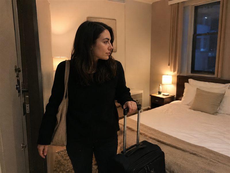 A woman settling into a new room